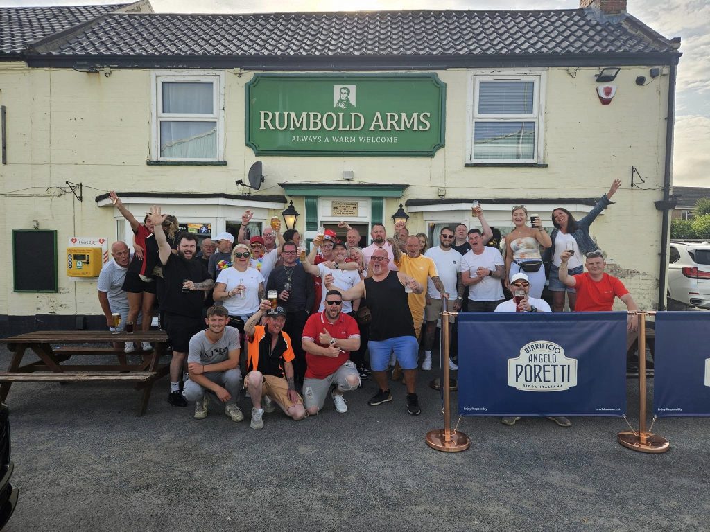 A group of people celebrating after a sponsored bike ride