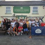 A group of people celebrating after a sponsored bike ride