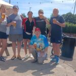 6 people standing with drinks