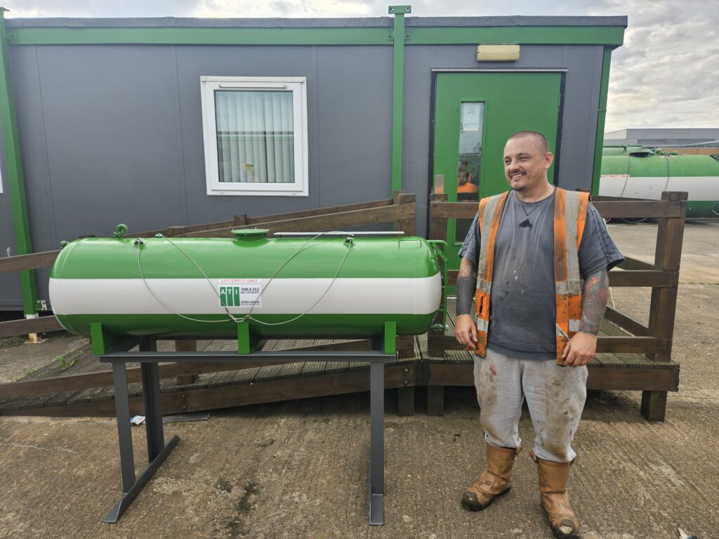 Person standing next to the miniature tank